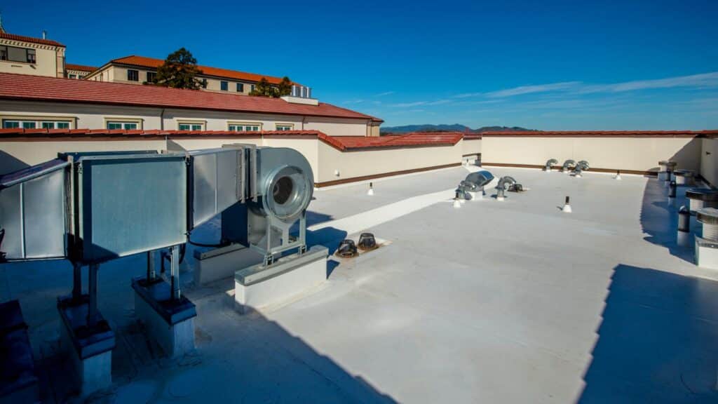 Flat rooftop with HVAC equipment, ventilation units, and ducts