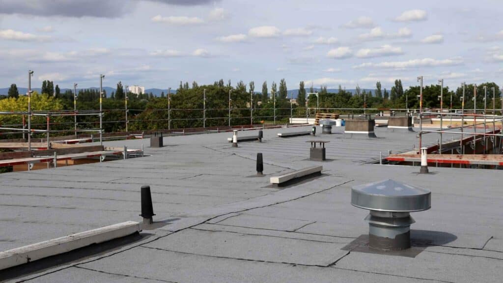 commercial flat top roof with ventilators and smoke stacks